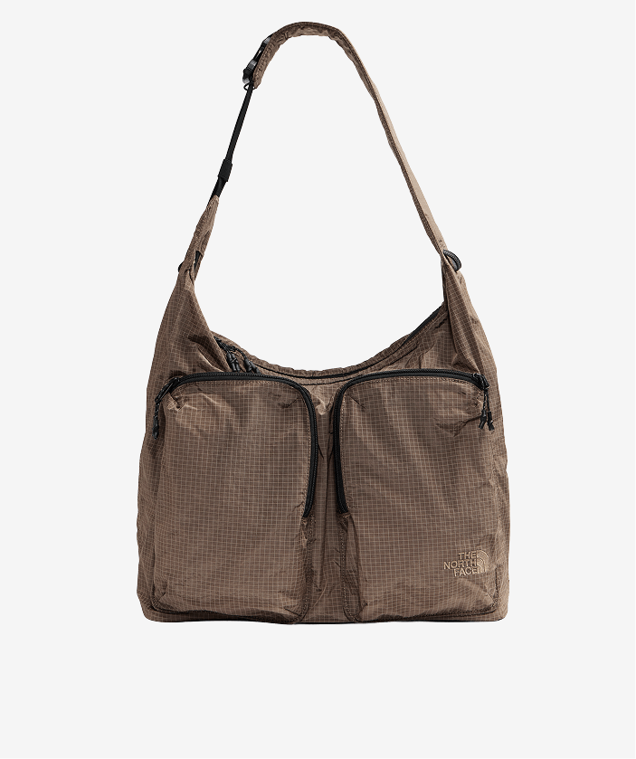 Brown Never Stop Tote on light gray background.