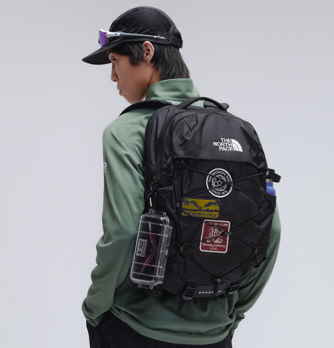 Person with Borealis backpack with patches