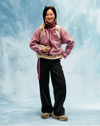 Young person wearing a purple fleece and black pants