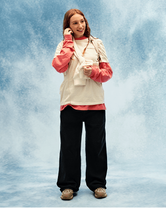 Young person wearing a white tee and black pants