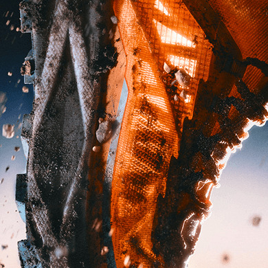 Closeup of the side of an orange Offtrail Ultra shoe, showing the details. 