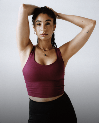 Women pulling back her hair wearing a Jaida Long Line Bra