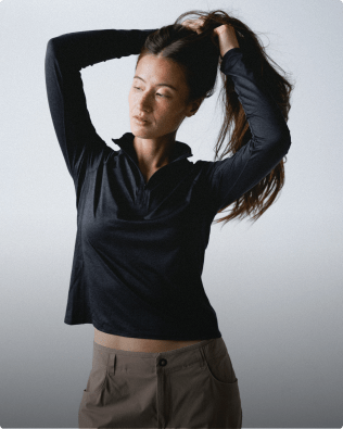 Women pulling back her hair wearing a Jaida 1/4 Zip