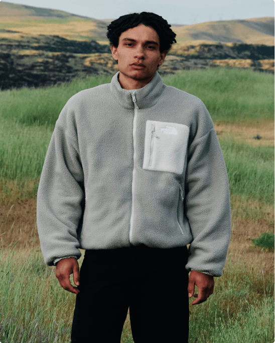 A man wearing the Lhotse fleece in a field