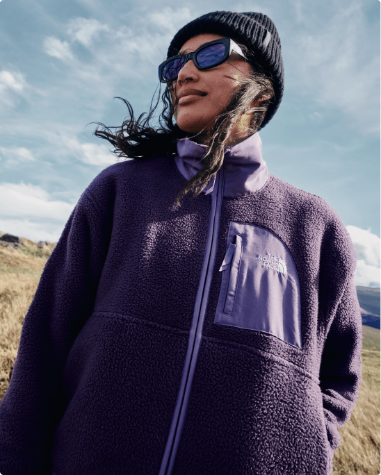 A man wearing the Lhotse fleece in a field