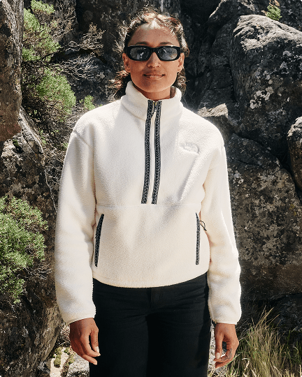 A woman hiking wearing a white Fleeski fleece