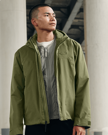 A man posing wearing a green TNF Range LT jacket