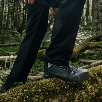 A guy stepping on a log