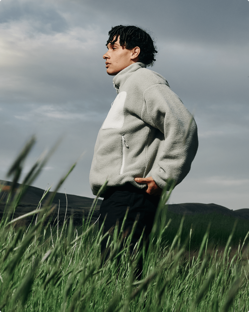 A man looking in the distance wearing a reversible Yumiori fleece