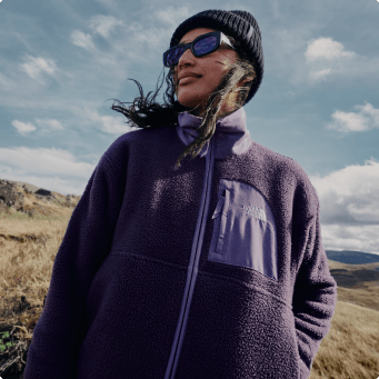 A woman wearing a purple Yumiori fleece