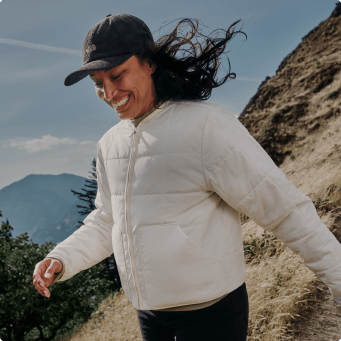 A woman wearing a white Lhotse lightweight jacket