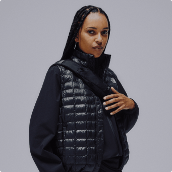 A woman wearing a black vest