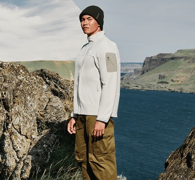A man standing wearing a grey Tek Approach jacket