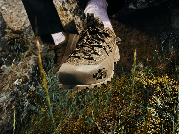 Close up of a brown shoe in the woods