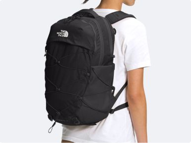 An image of a black backpack on a grey background