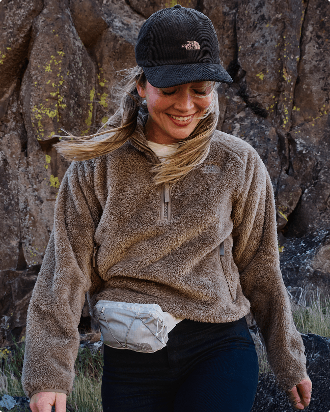 A woman wearing a tan Osito fleece
