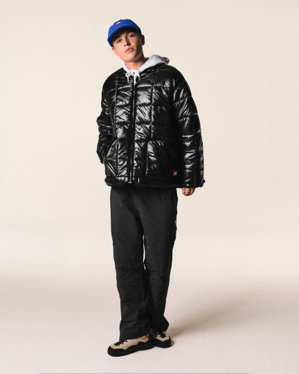 A guy posing wearing a black jacket from TNF Red Box