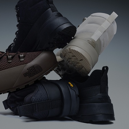 A bunch of shoes stacked on top of each other.