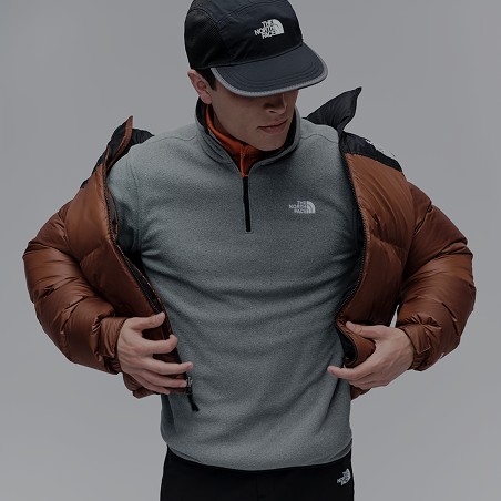 A man putting on a jacket.