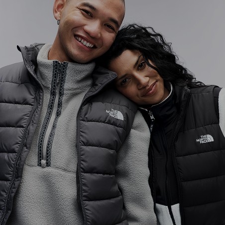 A woman's head resting on a man's shoulder wearing The North Face gear