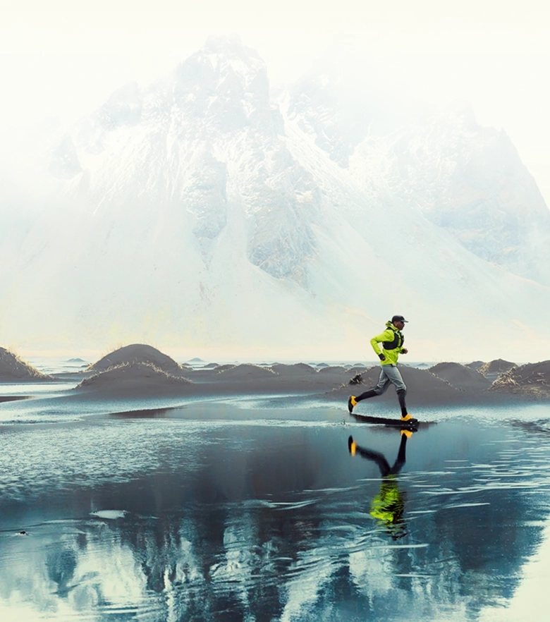 A runner strides across a scenic beach landscape.