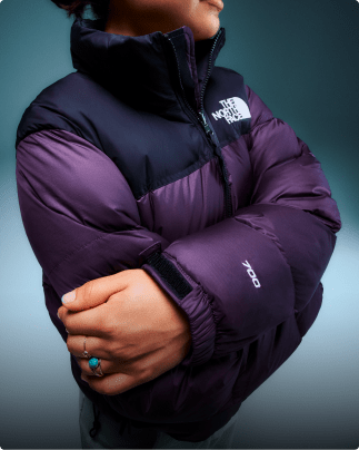 Closeup of a person wearing a purple 1996 Retro Nuptse jacket.