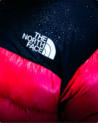 A closeup of a pink Summit Nuptse jacket.