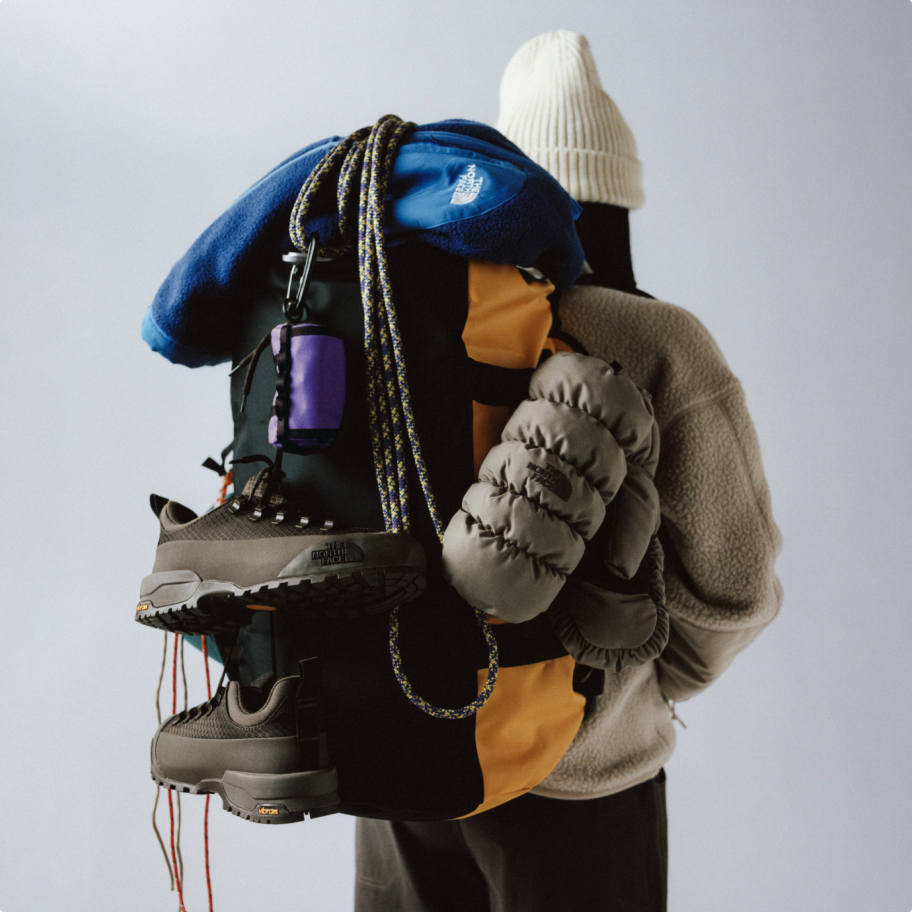 A picture of a person holding North Face Equipment