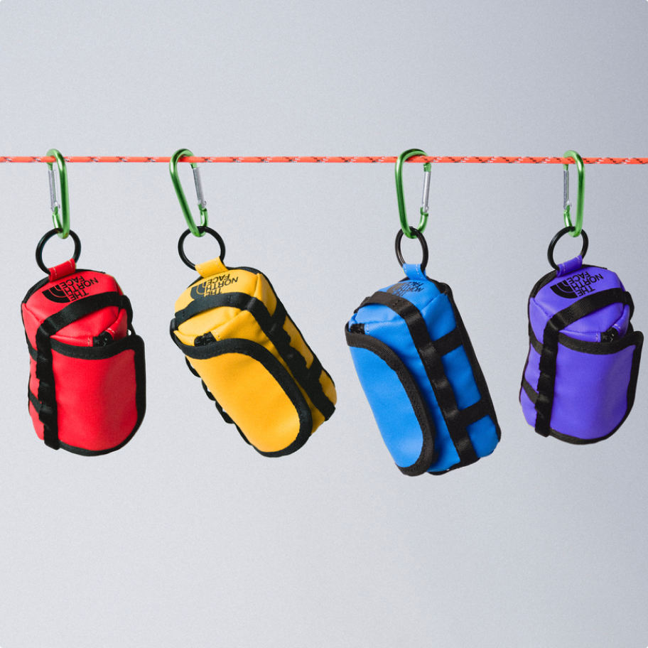 Mini duffel keychains hanging on a rope on a carabiner.