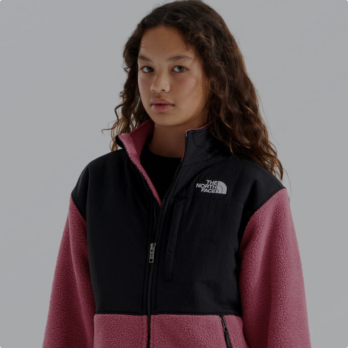 A girl wearing a pink and black Denali fleece from the North Face.