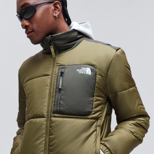 A man wearing a green Nuketo insulated jacket.