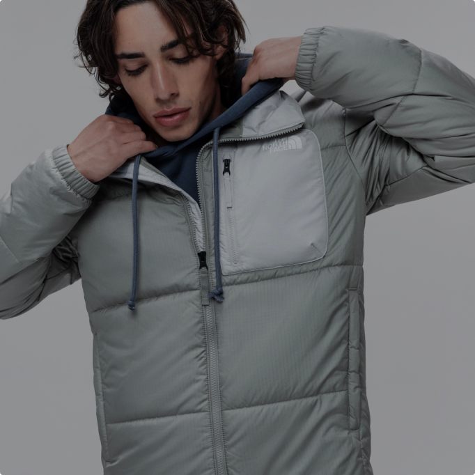 A man wearing a grey Nuketo insulated jacket.