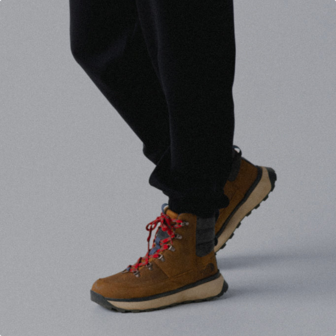 A person wearing tan winter boots.