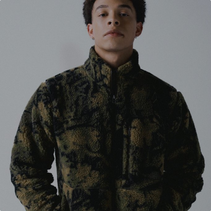 A man wearing a green patterned fleece.