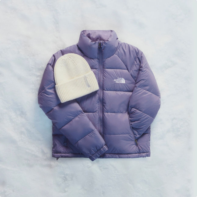 A bundle of women's products including a purple jacket and a white cuffed beanie.