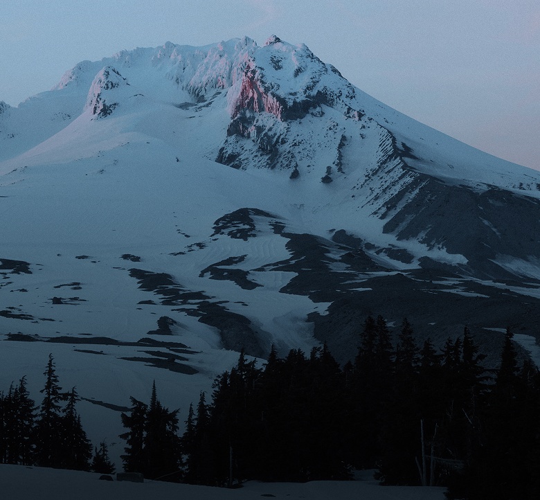 Picture of snowy mountains at dusk.