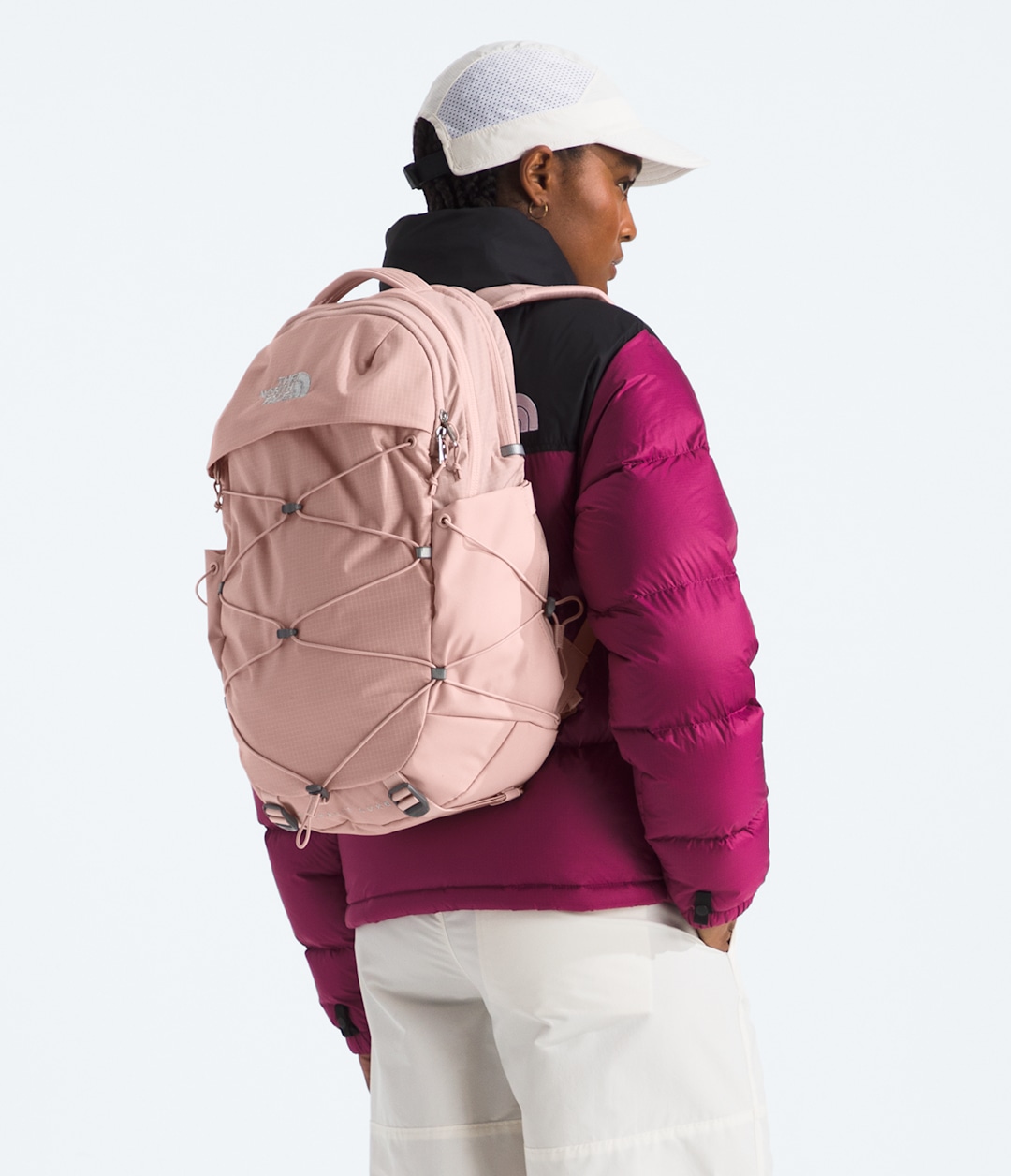 Studio image of a woman wearing sportswear from The North Face.