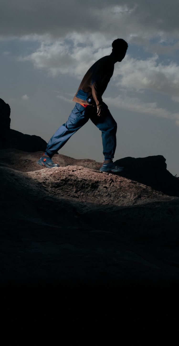 A hiker wearing SOUKUU™ gear from UNDERCOVER and The North Face.