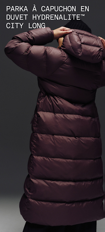 A full body video of a female wearing The North Face Hydrenalite City Long Down Hooded Parka.