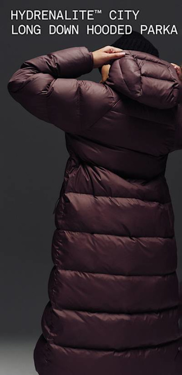 A full body video of a female wearing The North Face Hydrenalite City Long Down Hooded Parka.