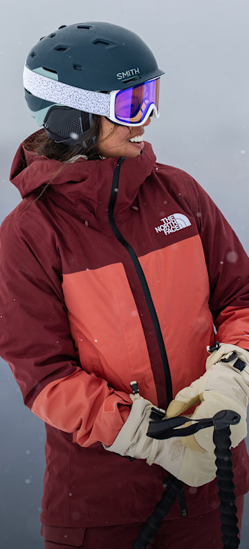 A skier wearing The North Face Women’s THERMOBALL™ Snow Triclimate® Jacket in Sumac/Mars Dust