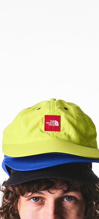 A guy wearing three hats