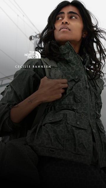 Model wearing The North Face x Cecilie Bahnsen Tenzin Convertible Jacket with utility pockets and convertible design.