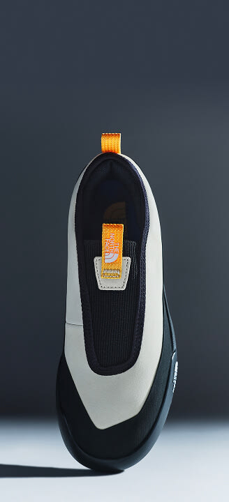 Close-up of The North Face Clyffe Slip-On Shoes in Desert Stone and TNF Black.