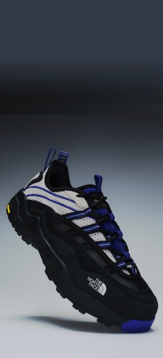 Floating product image of The North Face Clyffe Ultra Shoe in Desert Stone and TNF Blue. 