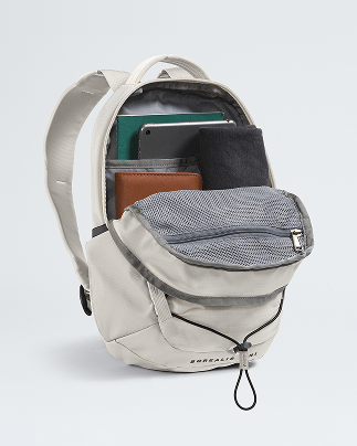 A white backpack is open, showing how it can fit a laptop, notebook, tablet and light sweater.
