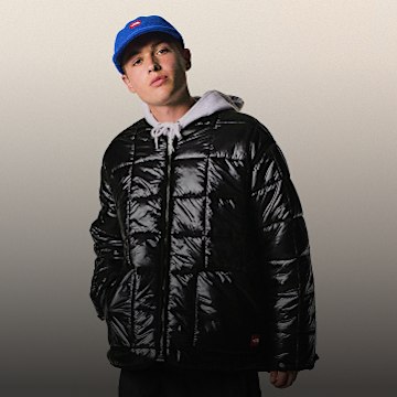 A guy posing wearing a black jacket from TNF Red Box