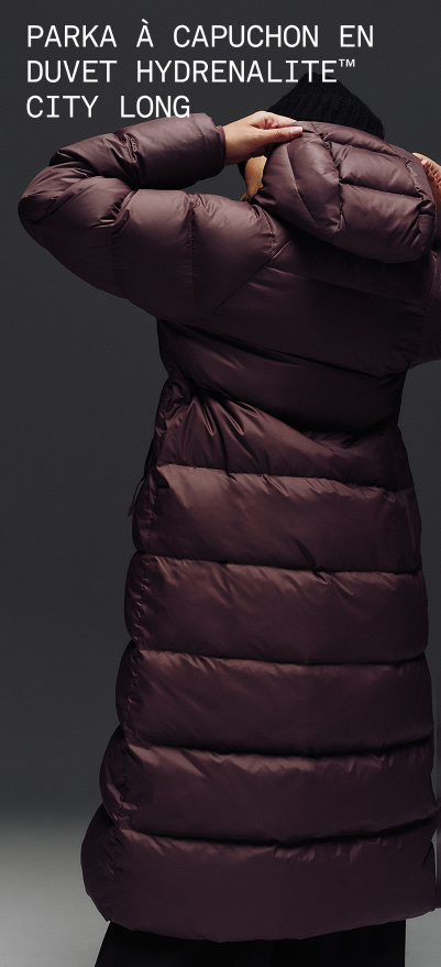 A full body video of a female wearing The North Face Hydrenalite City Long Down Hooded Parka.