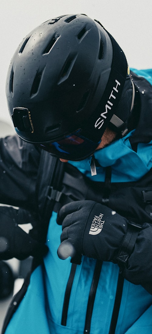 A snowboarder wearing The North Face Men’s Chakal Jacket in Dusk Blue/TNF Black.