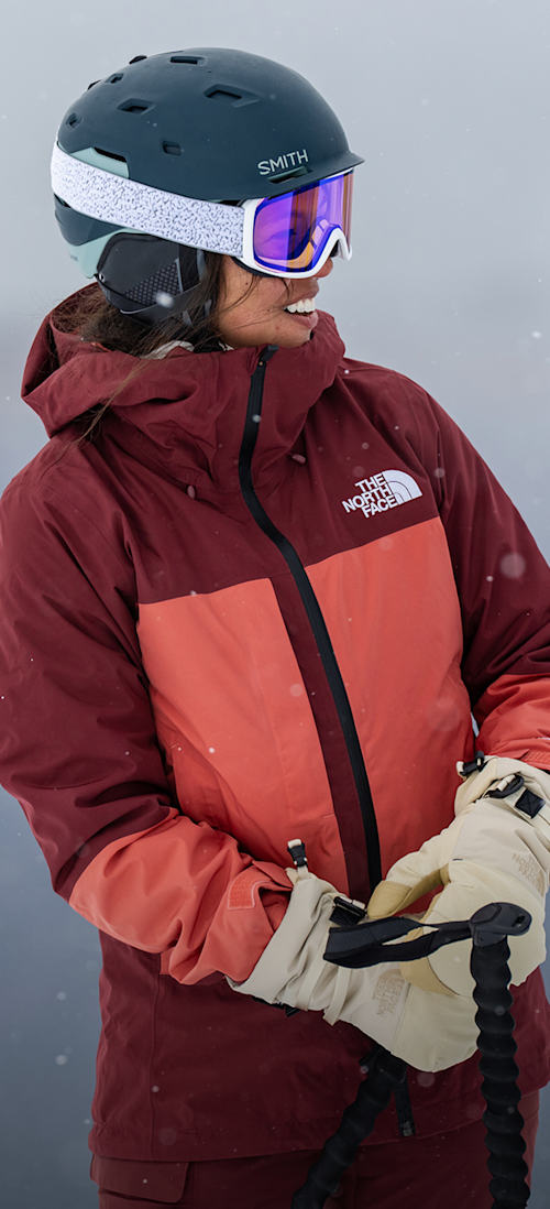 A skier wearing The North Face Women’s THERMOBALL™ Snow Triclimate® Jacket in Sumac/Mars Dust